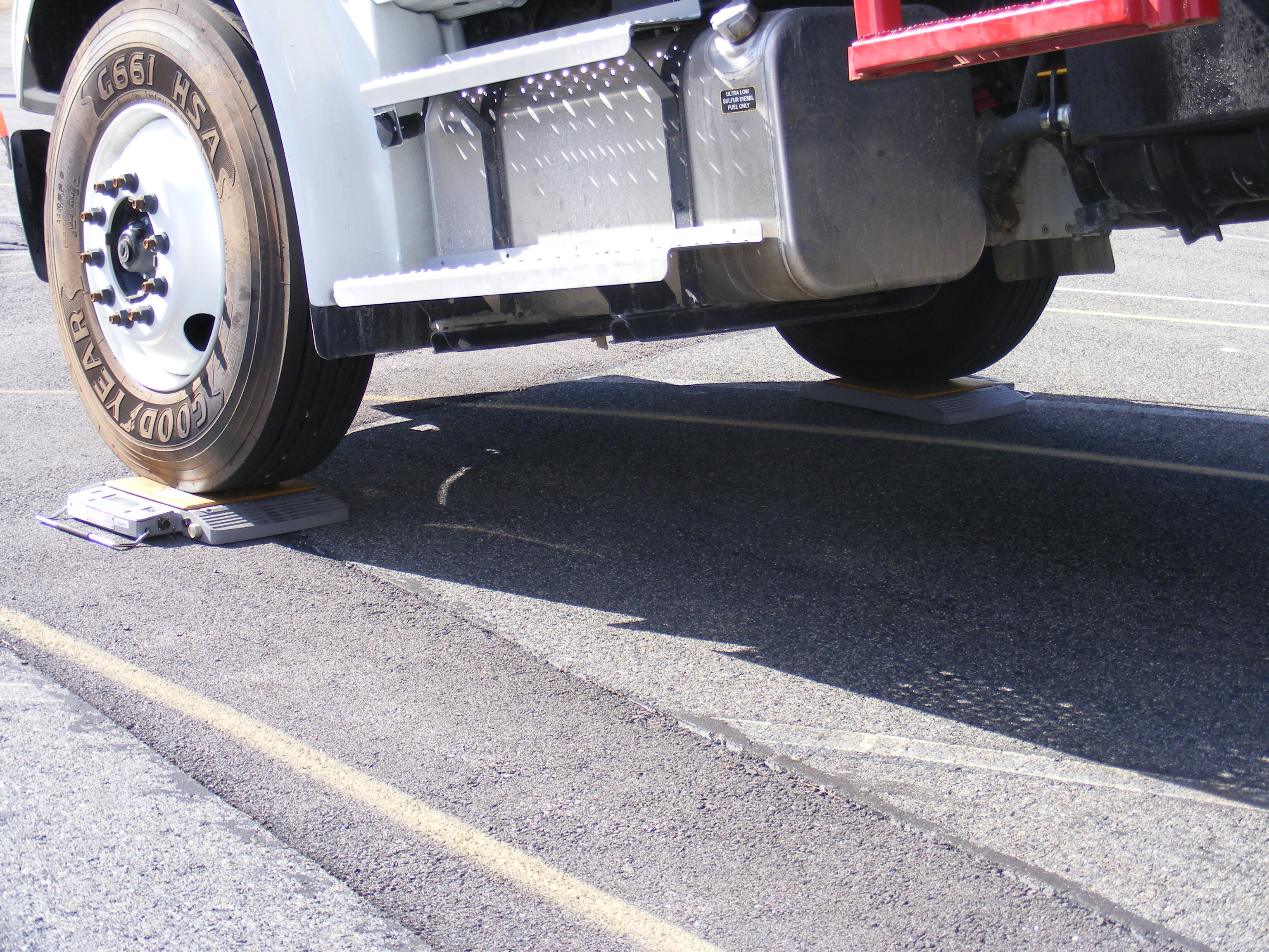 A Heavy Vehicle with front tires on scale